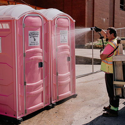 Stinky Pinky Portable Toilet Services cleaning off portable toilets